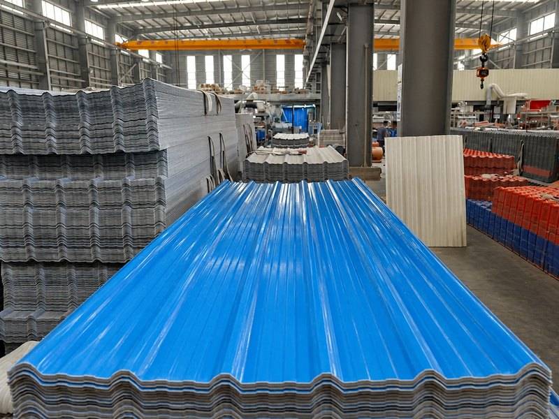 Stacks of corrugated plastic roofing sheets inside the HESU factory